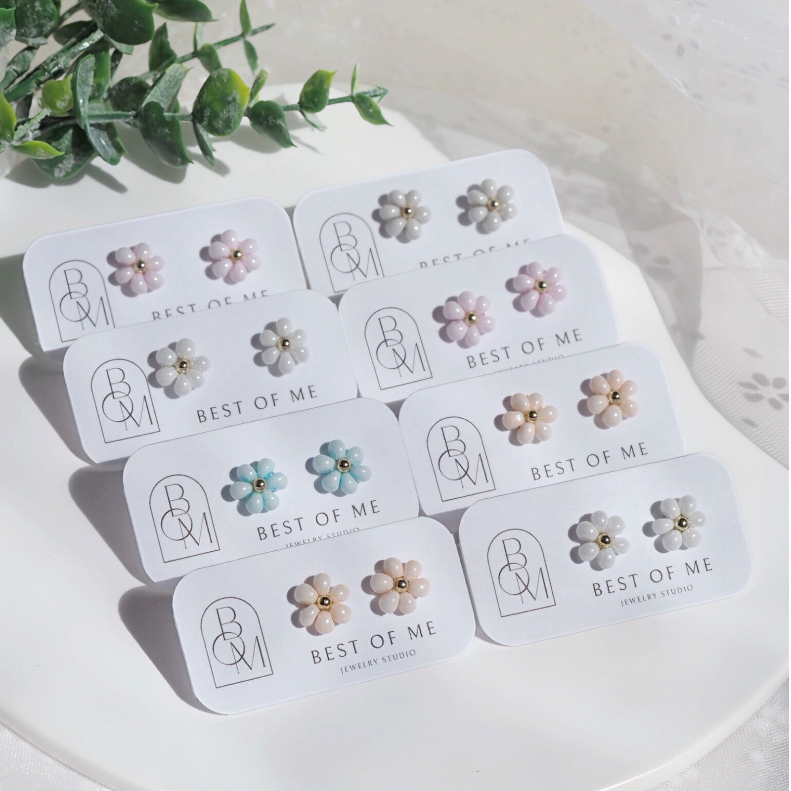 Set of handmade floral earrings on branded cards with 'Best of Me' branding.
