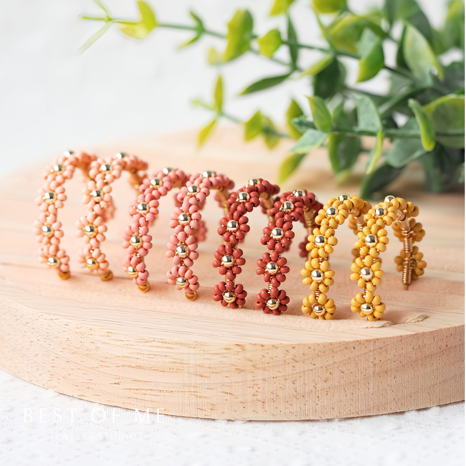 Vintage bloom earrings ,handmade flower earrings in mustard, mauve, reddish brown, and coral beige on a neutral back ground.