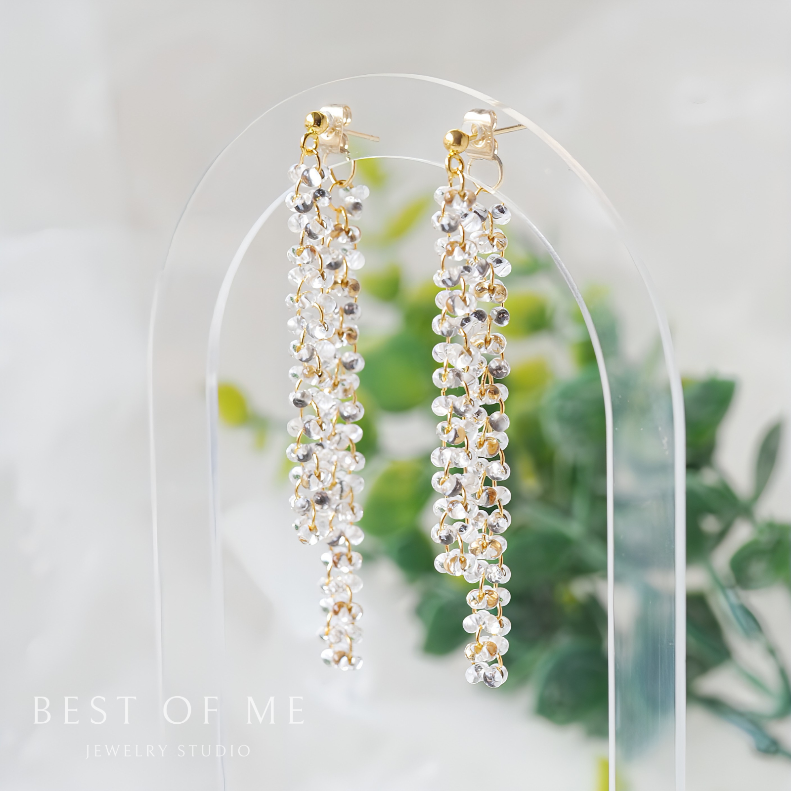 Pair of  delicate  clear beaded earrings on a white background with 'Best of Me Jewelry Studio' branding.