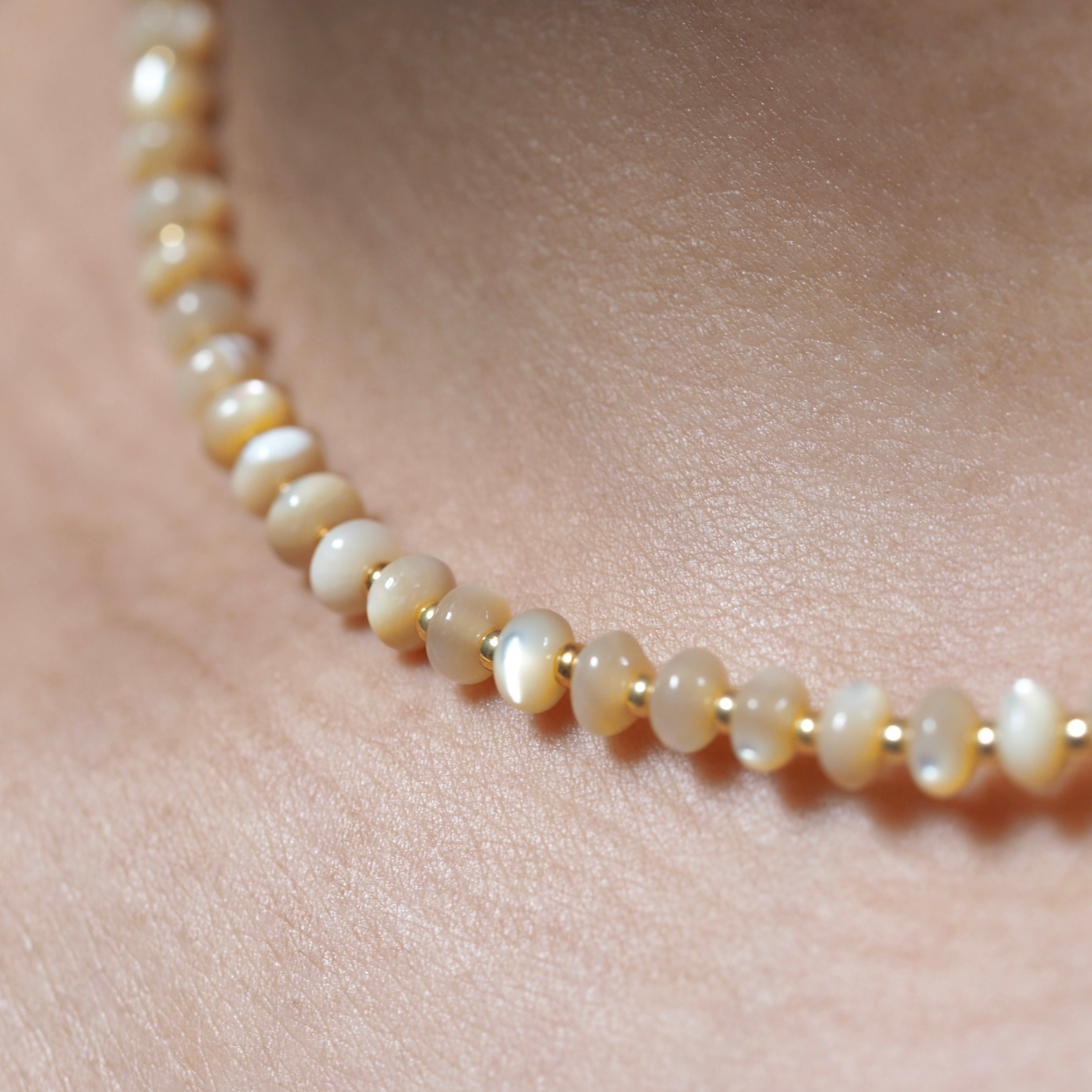 Dreamtide Dune beige iridescent glass bead choker necklace on skin, close-up detail, handcrafted in British Columbia Canada