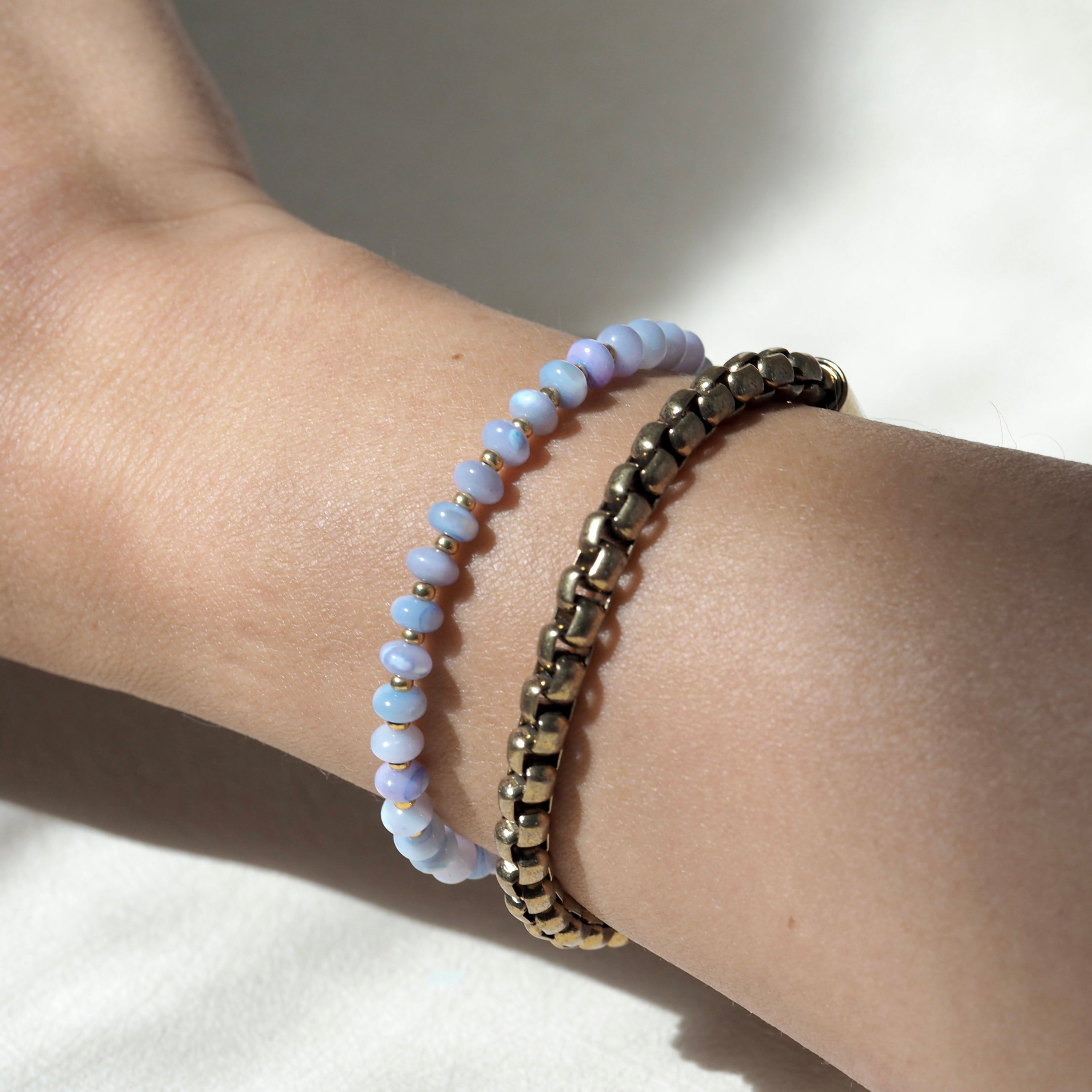 Dreamtide Tide iridescent glass bead bracelet stacked on wrist, minimalist jewelry Canada