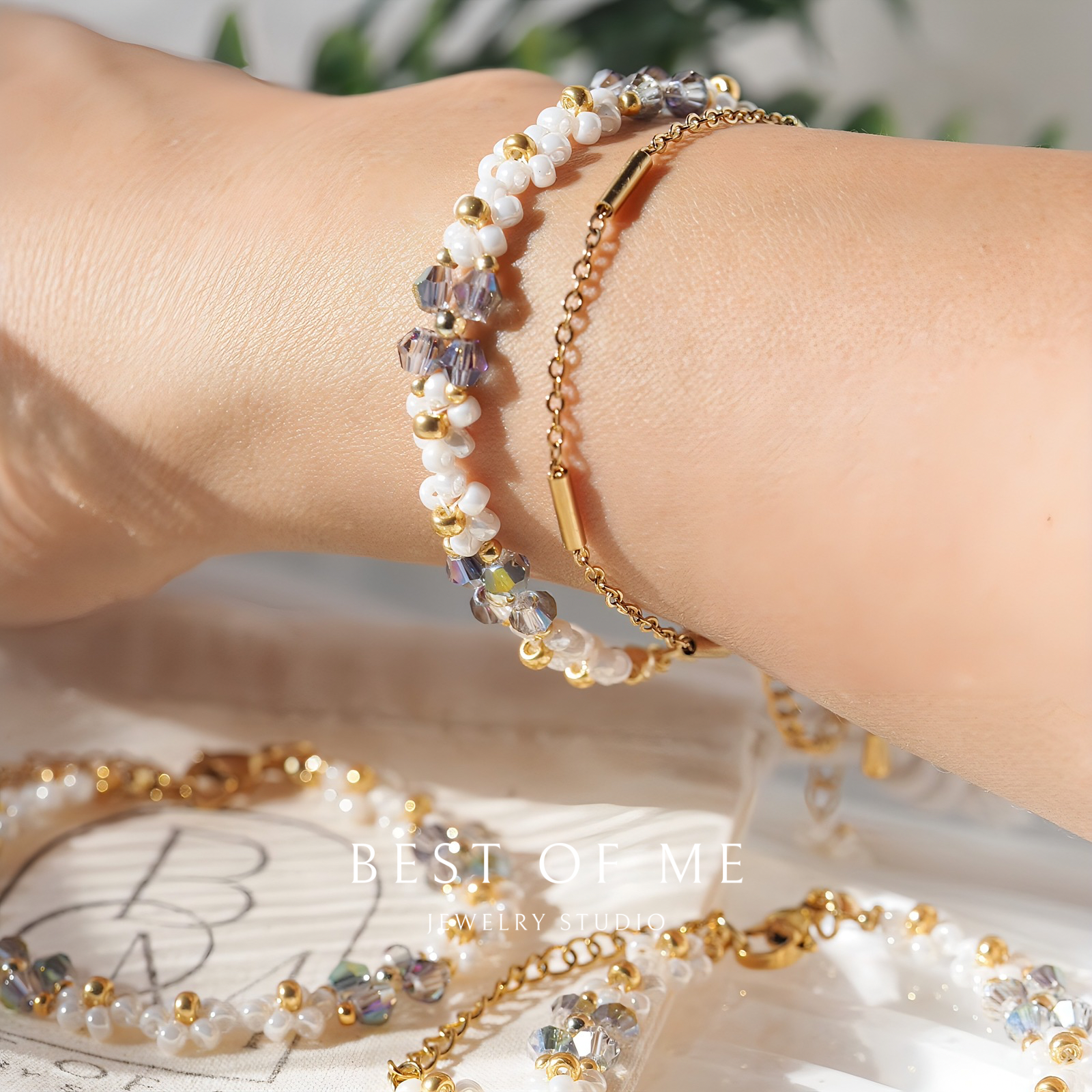 Close-up of a wrist wearing a beaded flower bracelet with a blurred background