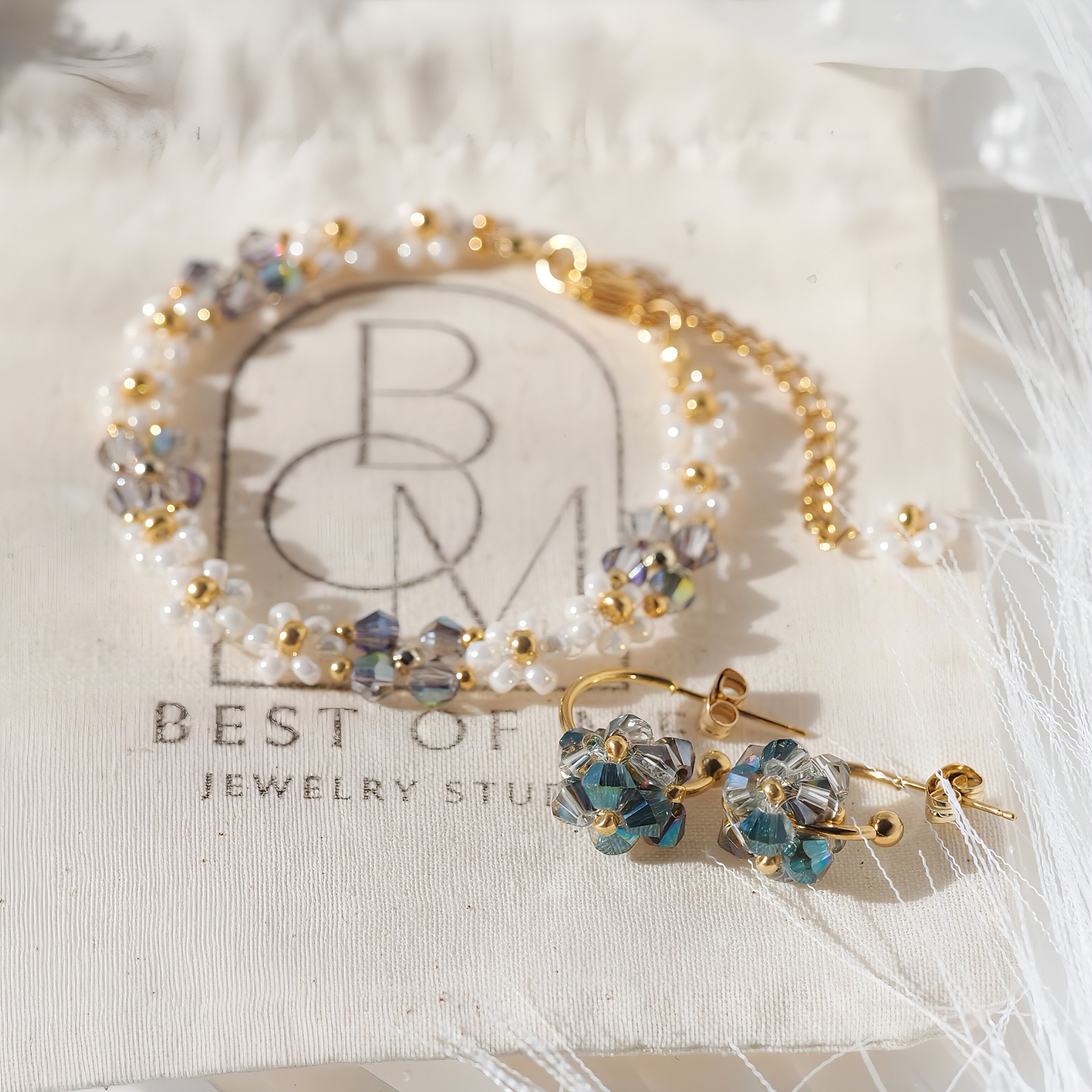 handmade elegant Jewelry set with bracelet and earrings on a Best of Jewelry Studio branded jewelry bag.