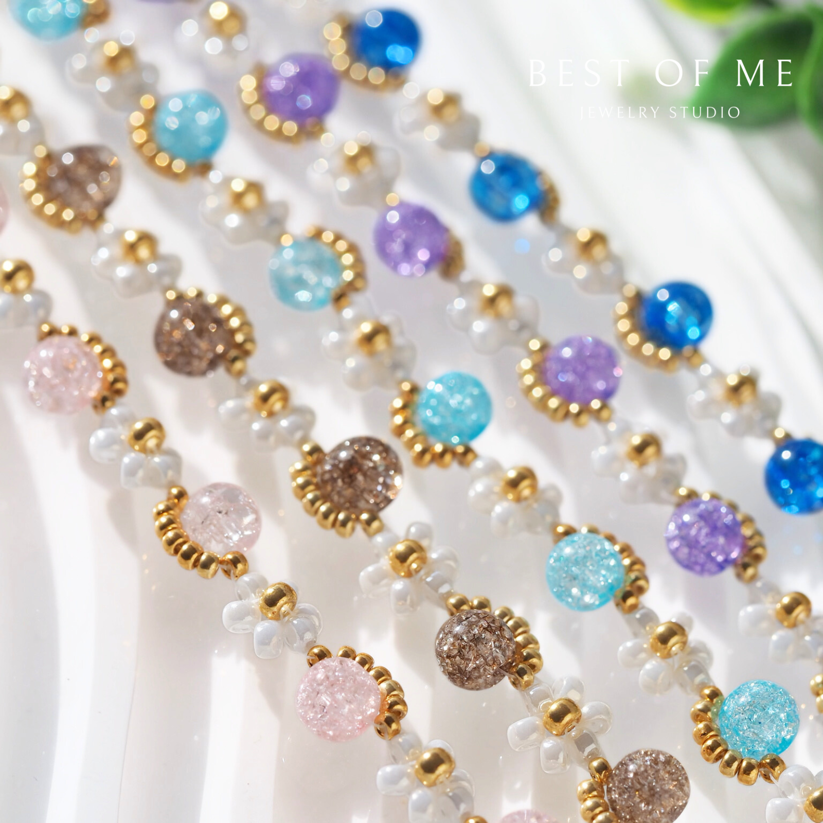 Close-up of a beaded flower bracelet  with multicolored beads on a white background, featuring the brand 'Best of Me'.