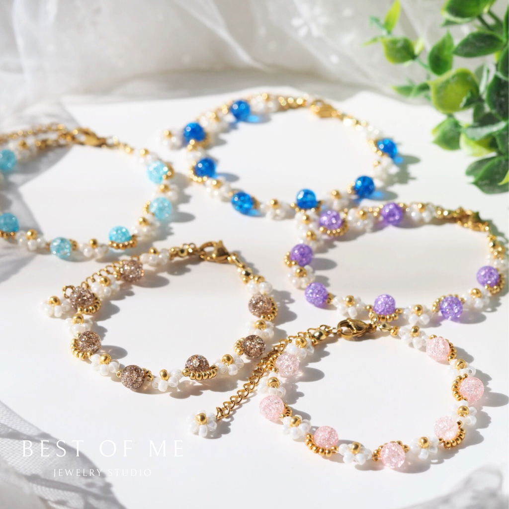 beaded handmade flower bracelets with multicolored beads on a white fabric background