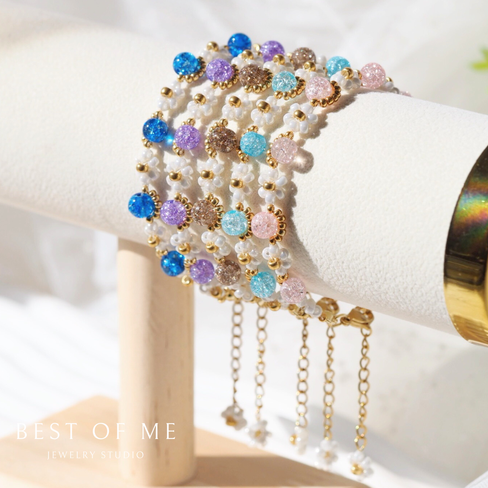 Multicolored beaded handmade flower bracelet on a white surface with 'Best of Me' branding.